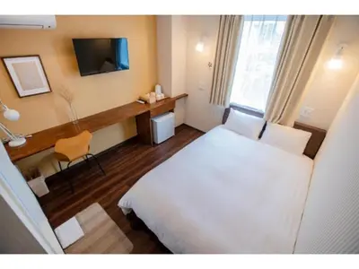 a hotel room with a white bed and a desk at ELE HOTEL Higashi Ueno - Vacation STAY 08004v in Tokyo