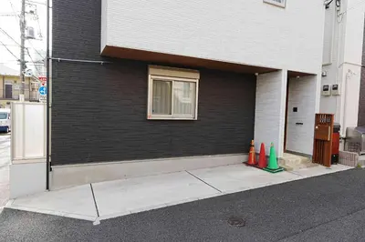 a corner of a house with a window and some cones at 100 INN Standard in Tokyo