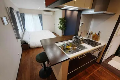 a kitchen with a sink and a bed in a room at 100 INN Standard in Tokyo