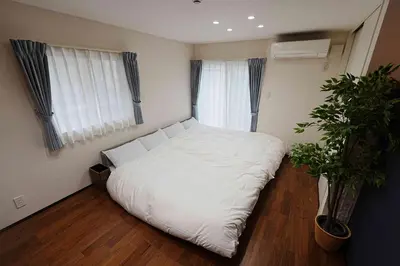 a bedroom with a white bed and a potted plant at 100 INN Standard in Tokyo