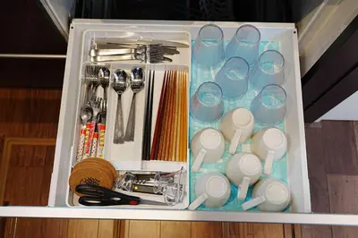 a drawer filled with cups and other utensils at 100 INN Standard in Tokyo