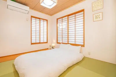 a bedroom with a white bed and two windows at ZSF-Minaminagazaki House-TS0317 in Tokyo