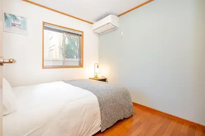 a white bedroom with a bed and a window at ZSF-Minaminagazaki House-TS0317 in Tokyo