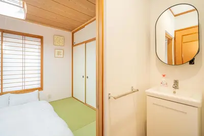 a small room with a bed and a mirror at ZSF-Minaminagazaki House-TS0317 in Tokyo