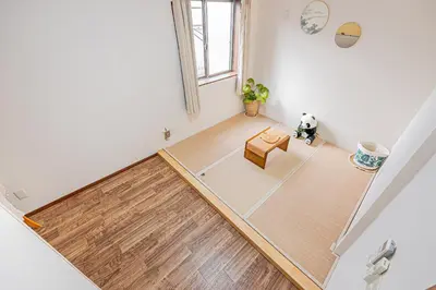 an aerial view of a living room with a wooden floor at W Hostel in Tokyo