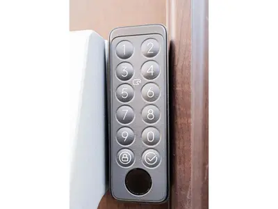 a remote control sticking out of a door at W Hostel in Tokyo