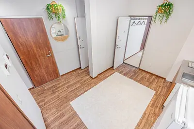 a hallway with a door and a rug at W Hostel in Tokyo