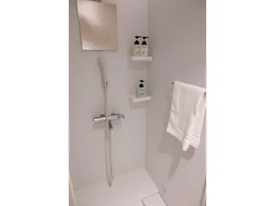 a white bathroom with a shower and white towels at ELE hotel Ginza East - Vacation STAY 15879v in Tokyo