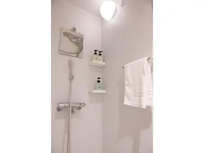 a bathroom with a shower and a toilet and a towel at ELE hotel Ginza East - Vacation STAY 15912v in Tokyo
