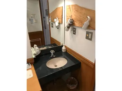 a bathroom with a sink and a mirror at Business Hotel Crescent - Vacation STAY 49082v in Tokyo