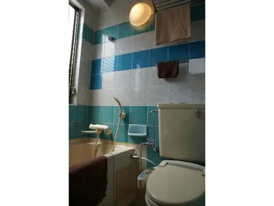 a bathroom with a toilet and a bath tub at Business Hotel Crescent - Vacation STAY 49947v in Tokyo