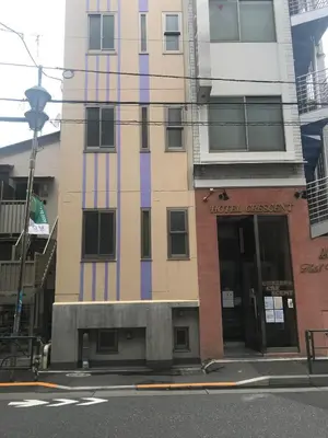 a tall building with purple paint on the side of it at Business Hotel Crescent - Vacation STAY 49947v in Tokyo
