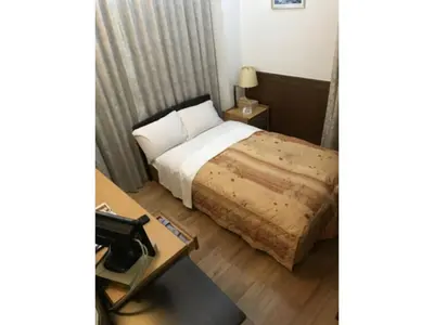 a hotel room with a bed and a table at Business Hotel Crescent - Vacation STAY 49938v in Tokyo