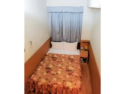 a small bed in a small room with a window at Business Hotel Crescent - Vacation STAY 49945v in Tokyo