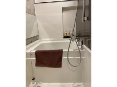 a bathroom with a bath tub with a towel at Business Hotel Crescent - Vacation STAY 49965v in Tokyo
