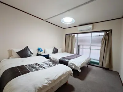 two beds in a room with a window at Mamada Building - Vacation STAY 17009 in Tokyo