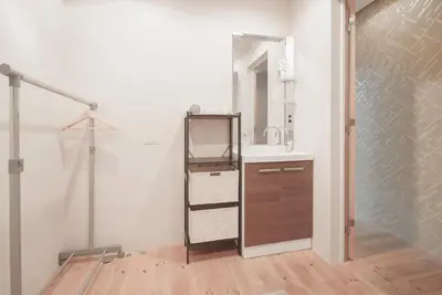 a bathroom with a sink and a mirror at OHAYO Hotel \u5927\u68ee\u897f in Tokyo