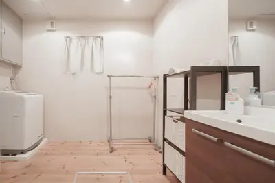 a bathroom with a shower and a sink and a toilet at OHAYO Hotel \u5927\u68ee\u897f in Tokyo