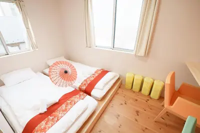 a small room with a bed and a window at OHAYO Hotel \u5927\u68ee\u897f in Tokyo