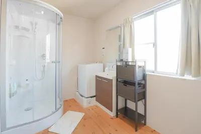 a bathroom with a shower and a sink at OHAYO Hotel \u5927\u68ee\u897f in Tokyo