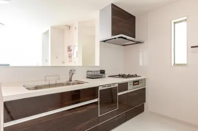 a kitchen with wooden cabinets and a sink at Good access 3LDK 15 people! Spacious room in Tokyo