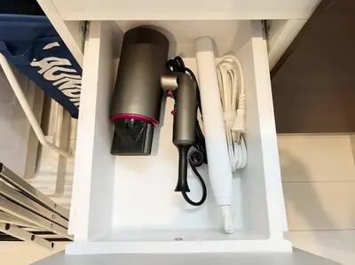 a black flashlight is hanging in a kitchen cabinet at Good access 3LDK 15 people! Spacious room in Tokyo