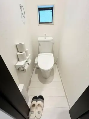 a bathroom with a toilet and a pair of slippers at Good access 3LDK 15 people! Spacious room in Tokyo