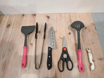 a group of kitchen tools on a wooden cutting board at \u30db\u30c6\u30eb\u9685\u7530\u5ddd in Tokyo