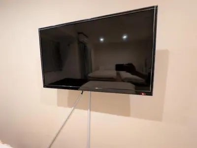 a flat screen tv hanging on a wall at \u30db\u30c6\u30eb\u9685\u7530\u5ddd in Tokyo