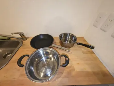 two pans sitting on top of a kitchen counter at \u30db\u30c6\u30eb\u9685\u7530\u5ddd in Tokyo