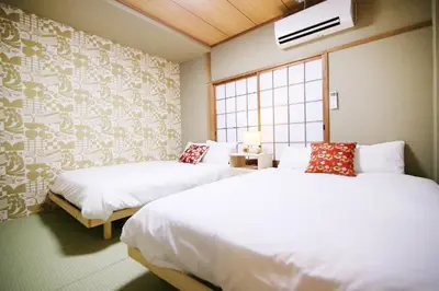 a bedroom with two beds and a window at KINO\u6d45\u8349b\u68df in Tokyo