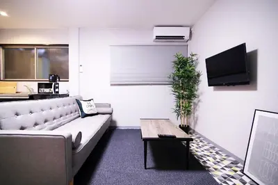 a living room with a couch and a table at KINO\u6d45\u8349b\u68df in Tokyo