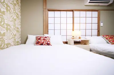 a bedroom with two beds and a couch at KINO\u6d45\u8349b\u68df in Tokyo