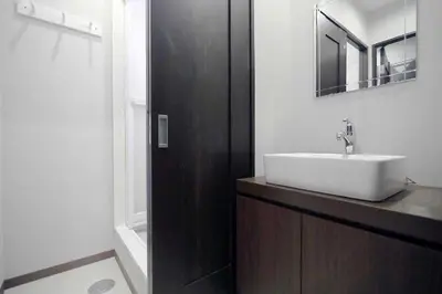 a bathroom with a white sink and a mirror at KINO\u6d45\u8349b\u68df in Tokyo