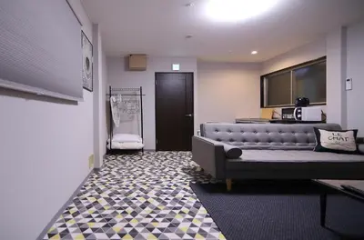 a living room with a couch and a tv at KINO\u6d45\u8349b\u68df in Tokyo