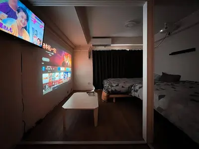 a room with a bed and a flat screen tv at Shinjuku 3 min walk from stationp #projector OH33 in Tokyo