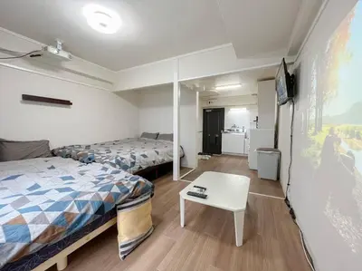 a room with two beds and a table in it at Shinjuku 3 min walk from stationp #projector OH33 in Tokyo