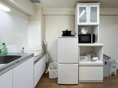 a white kitchen with a sink and a microwave at Shinjuku 3 min walk from stationp #projector OH33 in Tokyo