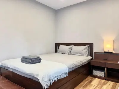 a bedroom with a bed and a nightstand with a bed sidx sidx at JUN \u6b4c\u821e\u4f0e\u753a10Floor-SJ0098 in Tokyo