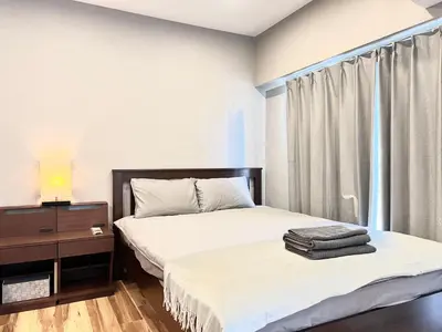 a bedroom with a bed and a dresser and a window at JUN \u6b4c\u821e\u4f0e\u753a10Floor-SJ0098 in Tokyo