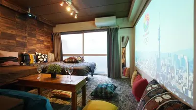 a living room with a couch and a table at Shinjuku 3 min walk from station projector #OH5 in Tokyo