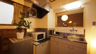 a kitchen with a sink and a microwave at Shinjuku 3 min walk from station projector #OH5 in Tokyo