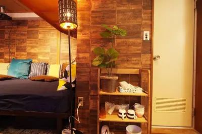 a room with a bed and a shelf with plants at Shinjuku 3 min walk from station #projector OH2-3 in Tokyo