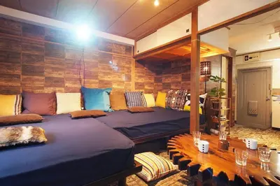 a room with two beds and a wooden wall at Shinjuku 3 min walk from station #projector OH2-3 in Tokyo