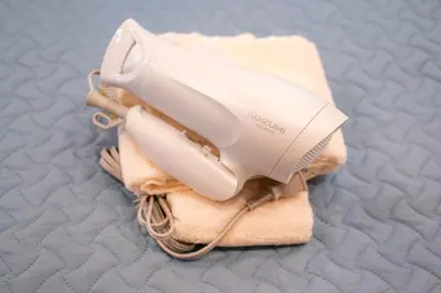 a white hair dryer sitting on top of a towel at Residence Hotel Ryogoku in Tokyo