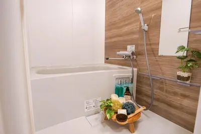 a bathroom with a shower and a bath tub at Residence Hotel Ryogoku in Tokyo