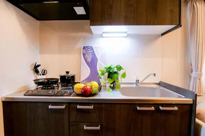 a kitchen with a sink and a stove at Residence Hotel Ryogoku in Tokyo