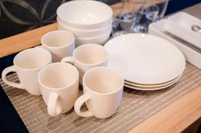 a group of white cups and plates on a table at Residence Hotel Ryogoku in Tokyo