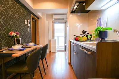 a kitchen with a table and chairs and a sink at Residence Hotel Ryogoku in Tokyo