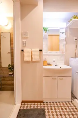 a bathroom with a sink and a mirror at Residence Hotel Ryogoku in Tokyo